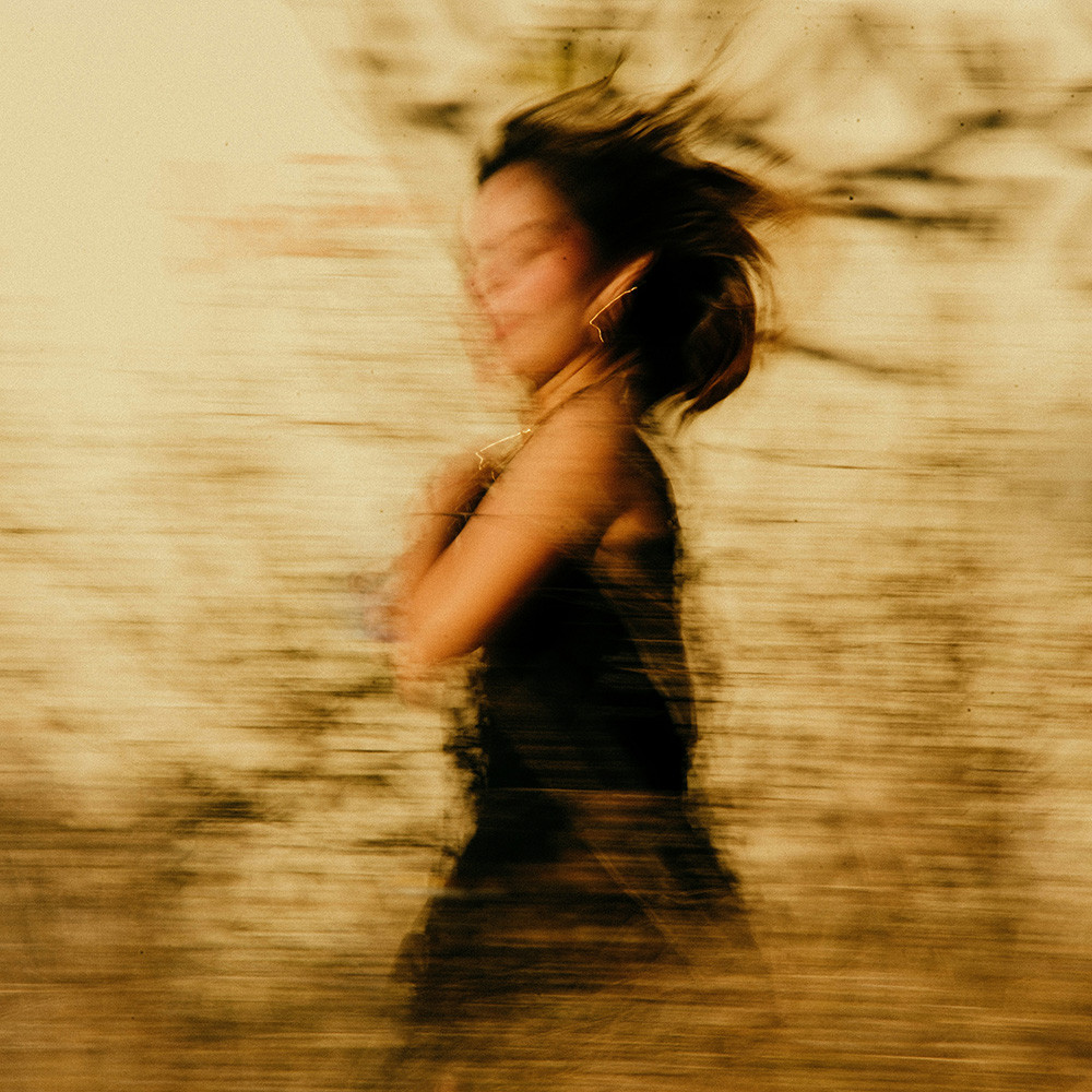 Woman spinning in warm golden light